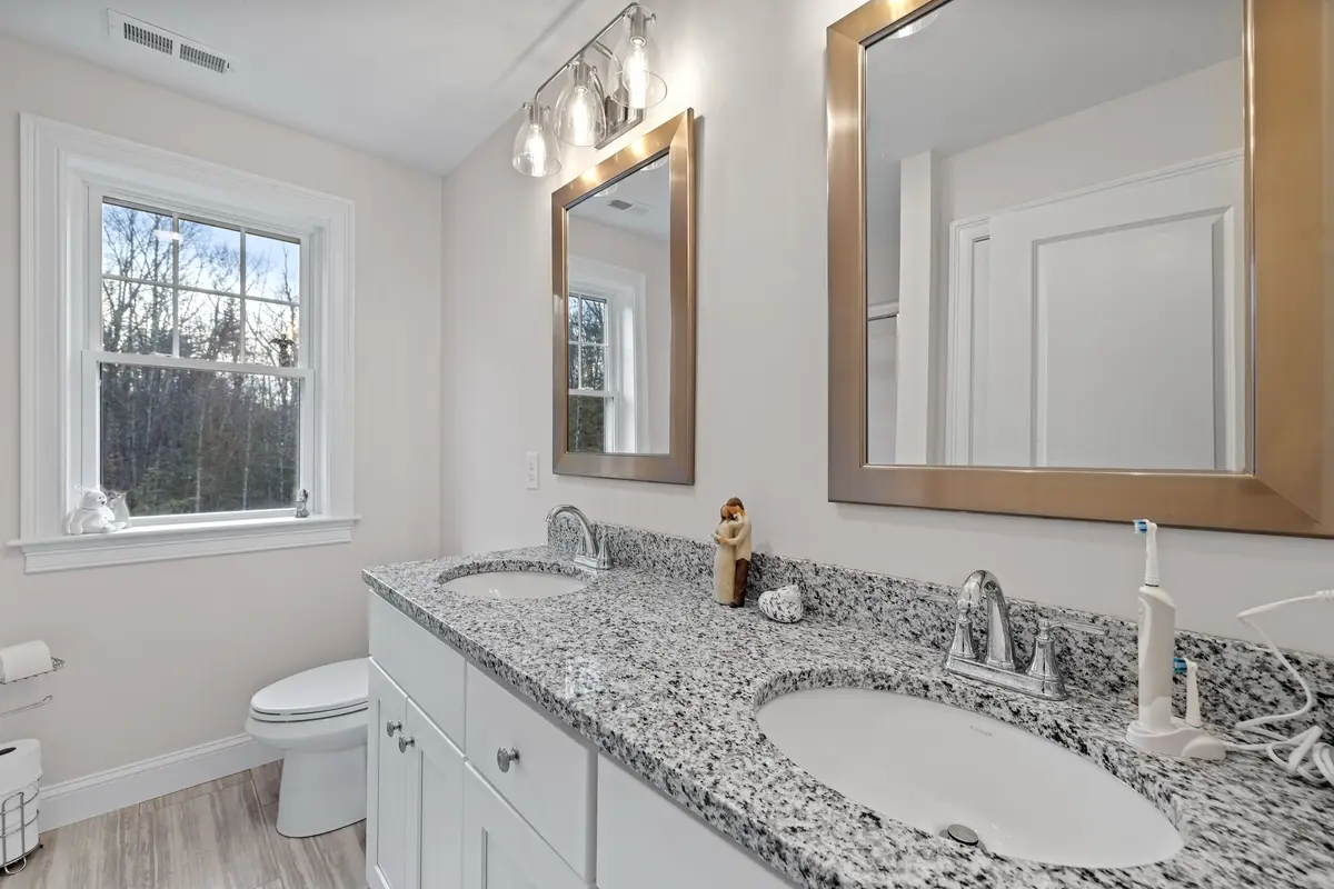 Bathroom with double vanity and granite counter